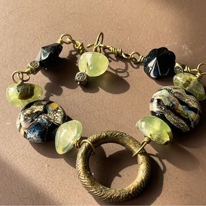 Beaded bracelet, lampwork glass, prehnite, black onyx, native African brass